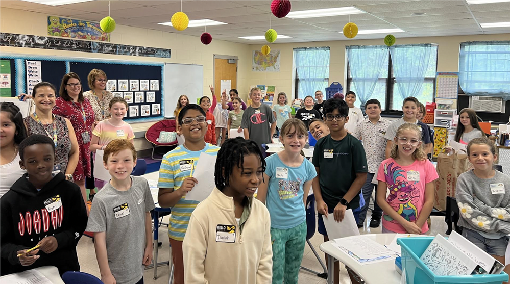 teacher and students working on classroom project